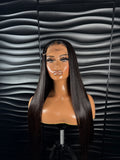 NICOLE glueless closure wig displayed on a mannequin with sleek straight hair and natural baby hairs against a textured backdrop.