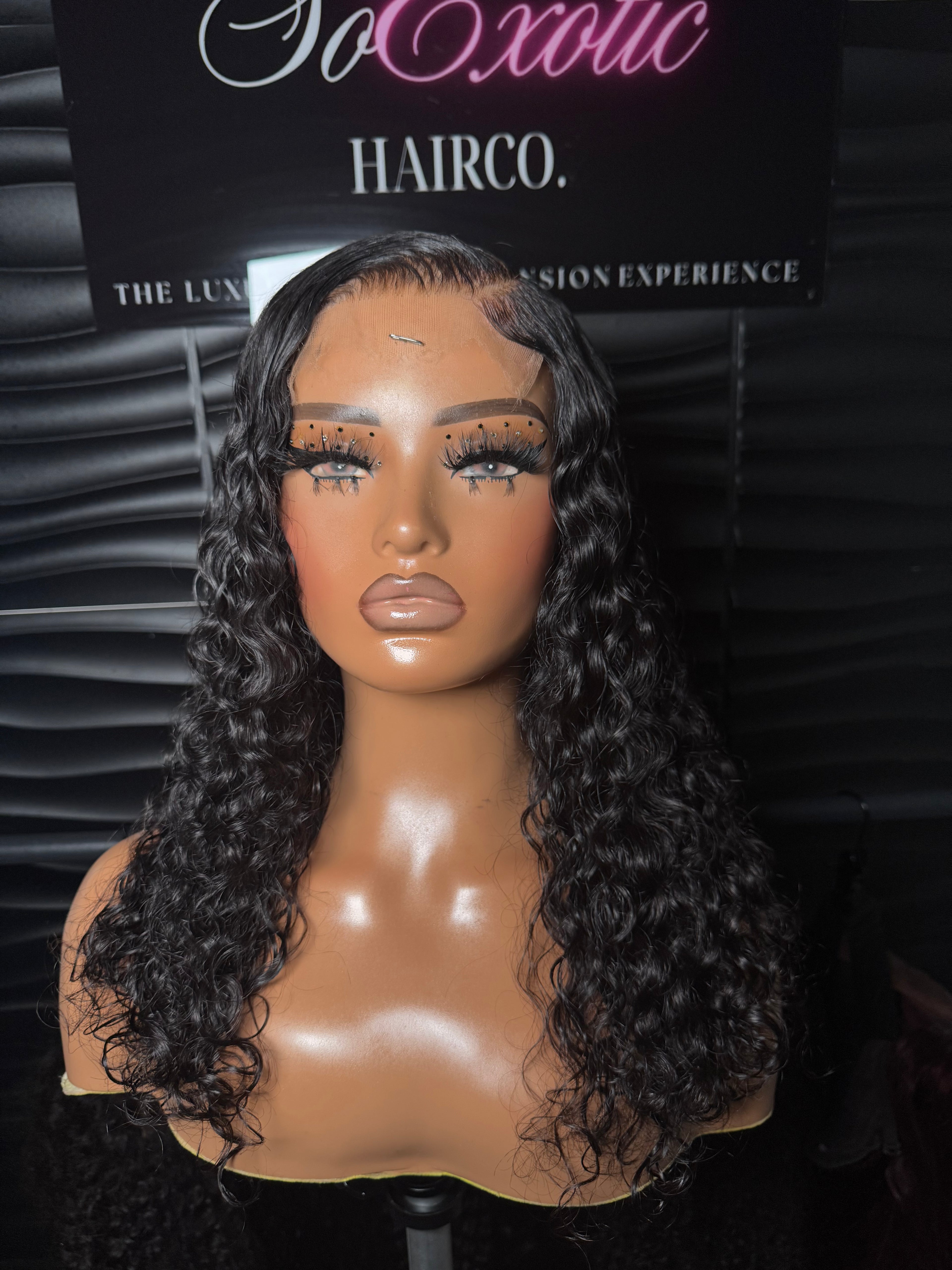 Kia signature wig styled with natural baby hairs, featuring luxurious curls and a sleek side part.