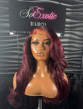 Janet wig displayed on mannequin with luxurious burgundy waves and natural baby hairs.